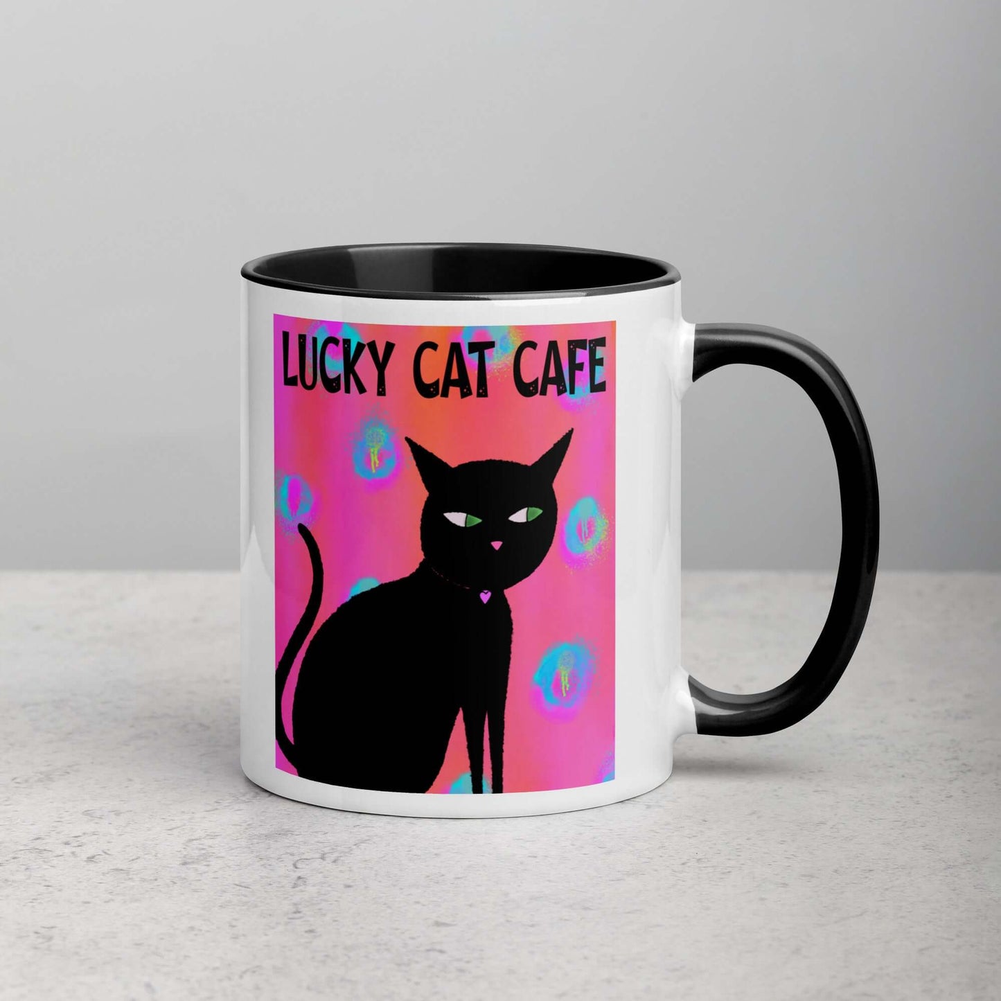 Black Cat on Hot Pink Tie Dye Background with Text “Lucky Cat Cafe” Mug with Black Color Inside Right Handed Front View