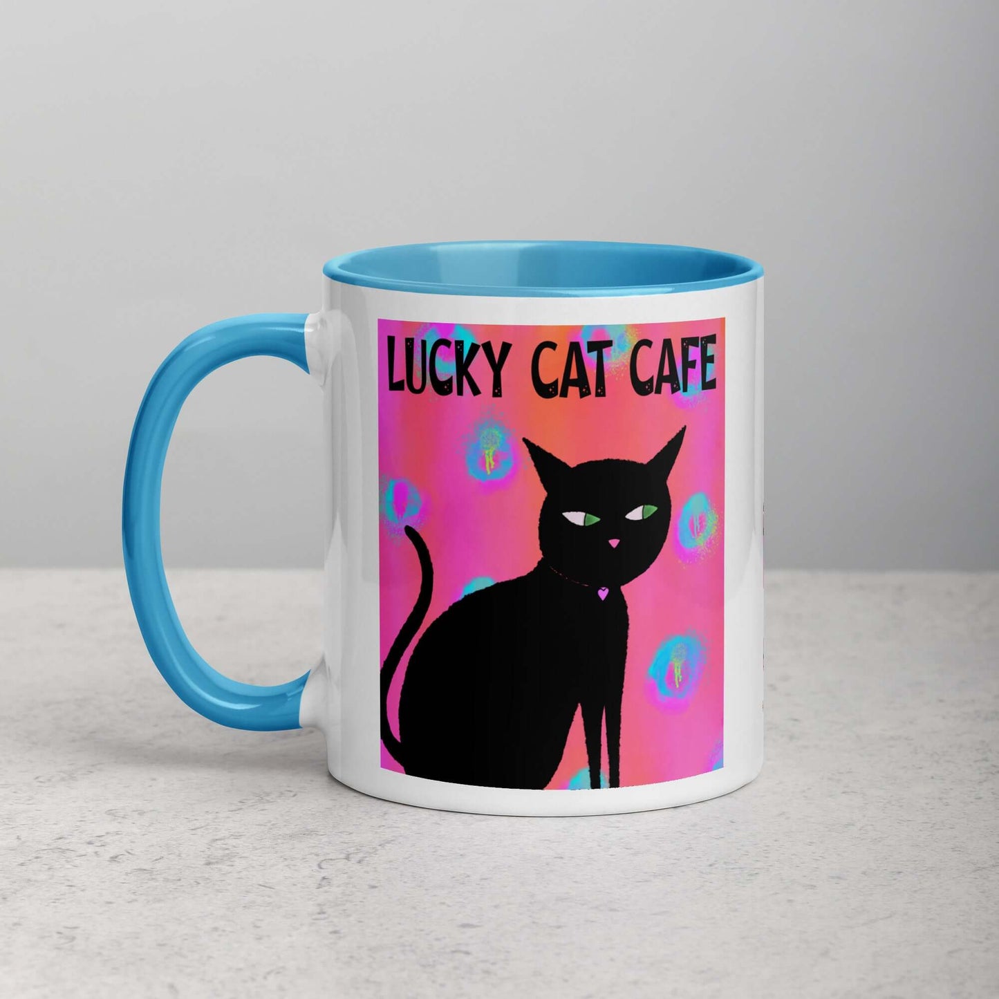 Black Cat on Hot Pink Tie Dye Background with Text “Lucky Cat Cafe” Mug with Light Blue Color Inside Left Handed Front View
