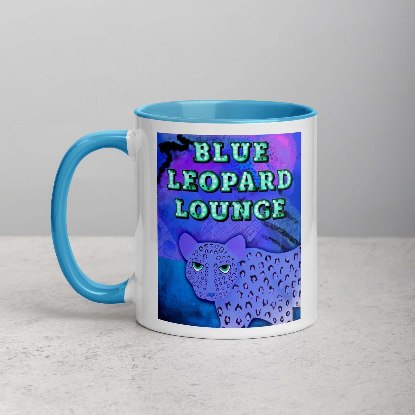 Purple Leopard on Blue and Purple Abstract Background with Text “Blue Leopard Lounge” Mug with Light Blue Color Inside Left Handed Front View