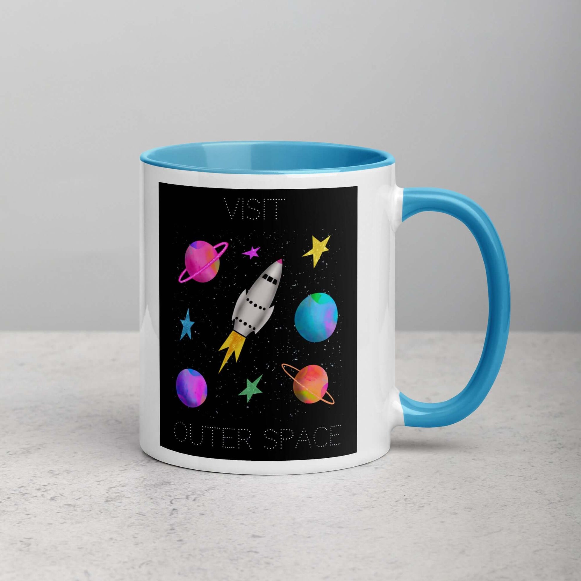 Whimsical Space Rocket with Colorful Planets and Stars on Black Background with Text “Visit Outer Space” Mug with Light Blue Color Inside Right Handed Front View