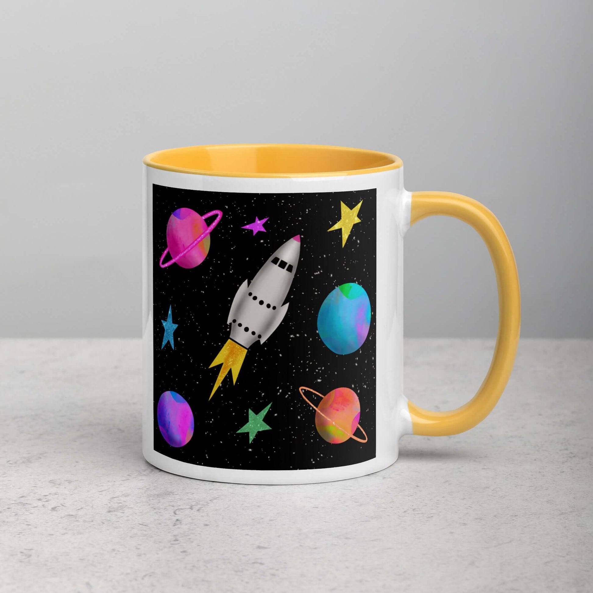 Whimsical Space Rocket with Colorful Planets and Stars on Black Background “Space Rockets” Mug with Golden Yellow Color Inside Right Handed Front View