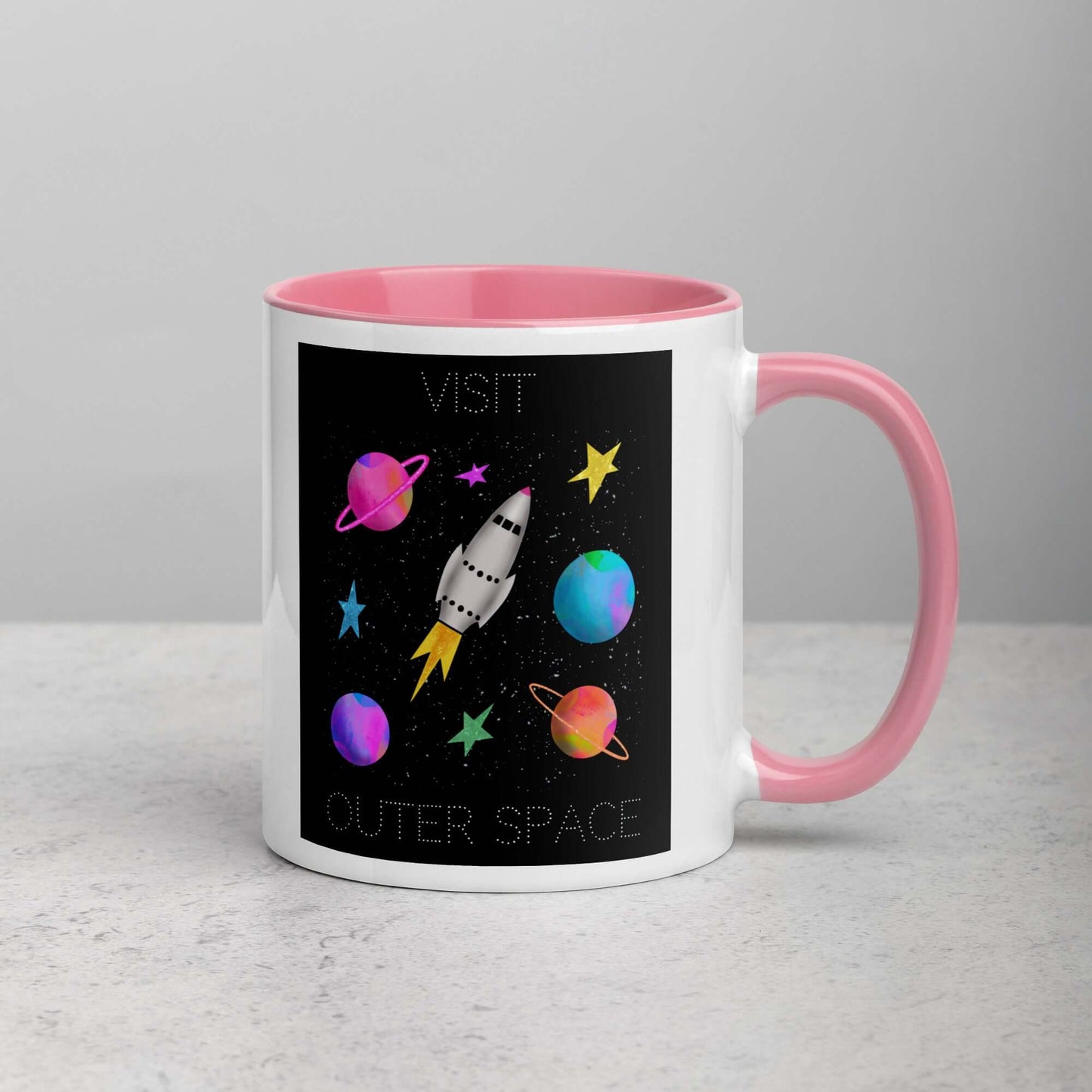 Whimsical Space Rocket with Colorful Planets and Stars on Black Background with Text “Visit Outer Space” Mug with Light Pink Color Inside Right Handed Front View