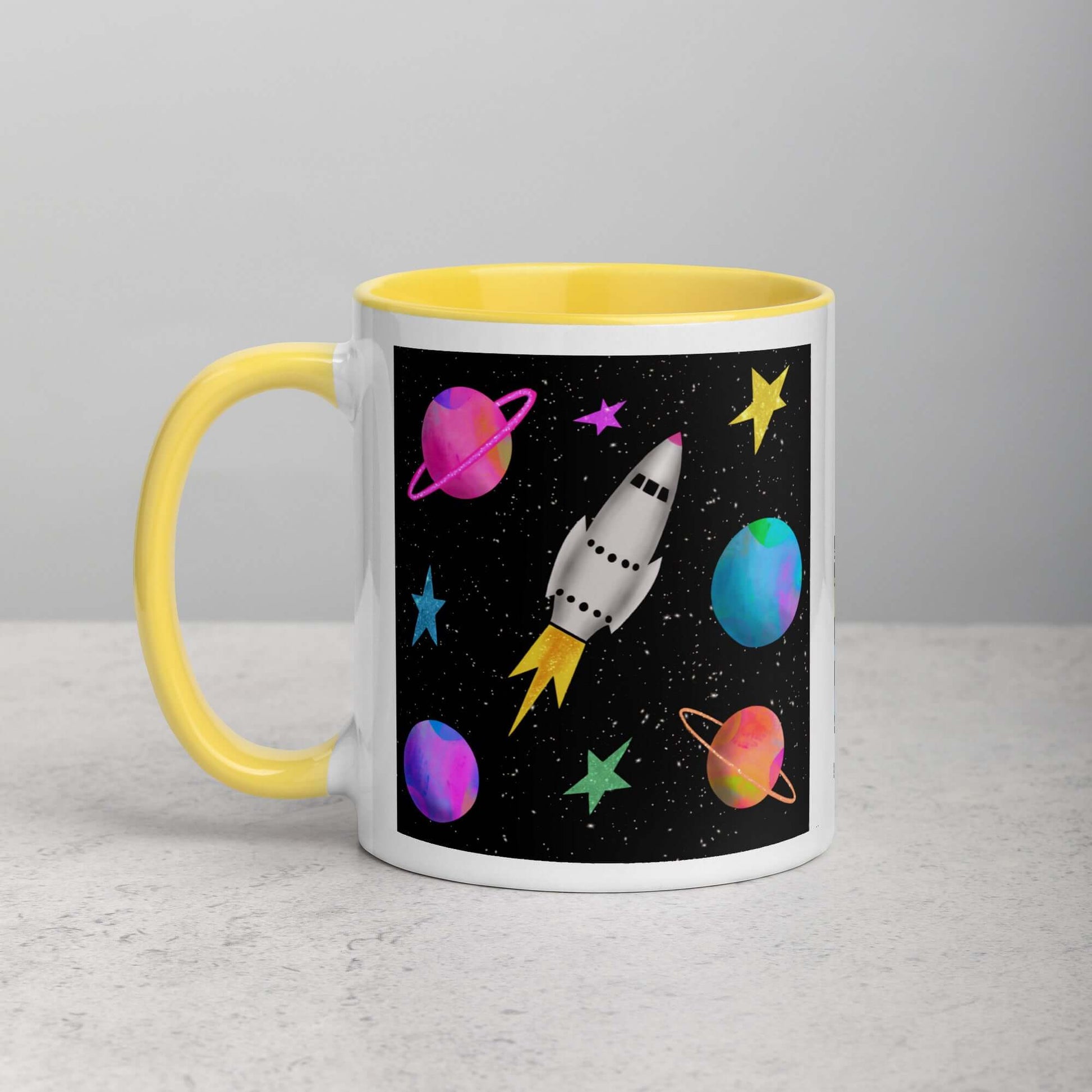 Whimsical Space Rocket with Colorful Planets and Stars on Black Background “Space Rockets” Mug with Bright Yellow Color Inside Left Handed Front View