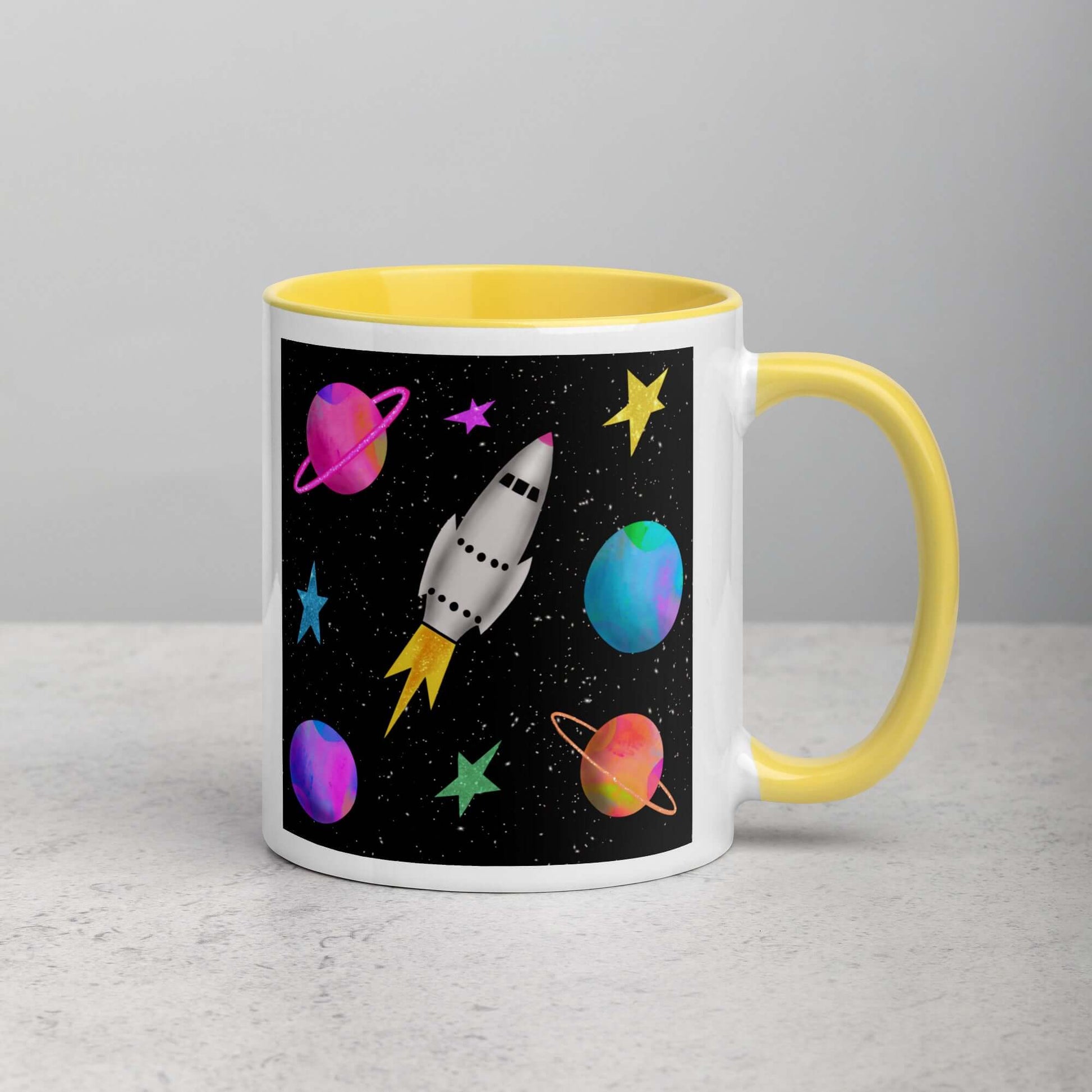Whimsical Space Rocket with Colorful Planets and Stars on Black Background “Space Rockets” Mug with Bright Yellow Color Inside Right Handed Front View