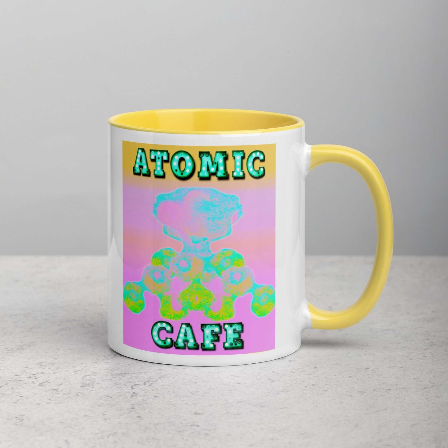 Pastel Atomic Blast with “Atomic Cafe” in Marquee Letters Mug with Bright Yellow Color Inside Right Handed Front View 
