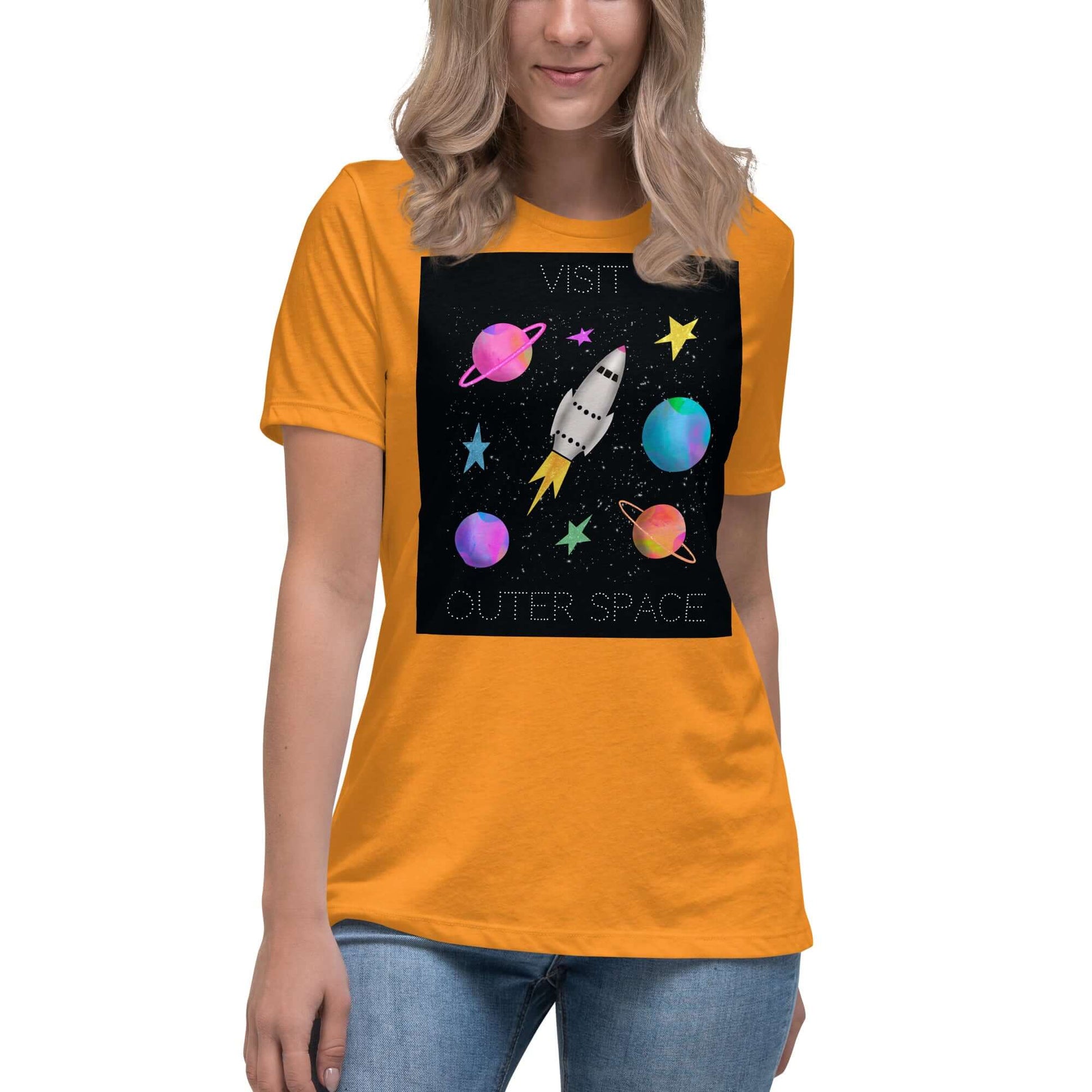 Whimsical Space Rocket with Colorful Planets and Stars on Black Background with Text “Visit Outer Space” Women’s Short Sleeve Tee in Heather Marmalade